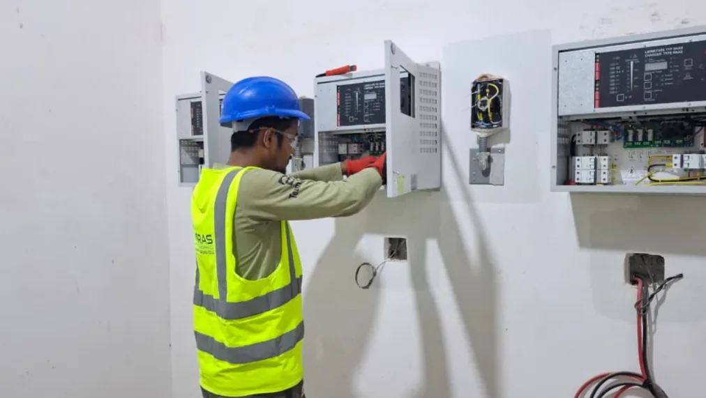 Technician servicing a control panel