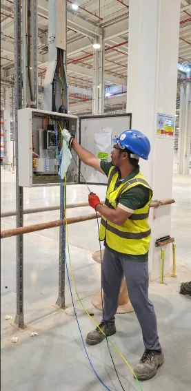 Field electrician carrying out technical work