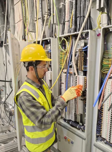 Electrical panel technician at work