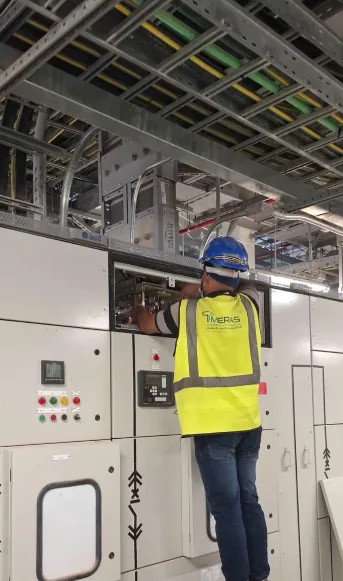 Switchgear technician performing electrical work